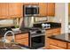 Stainless steel kitchen appliances including a gas range and microwave at 13747 W Nogales Dr, Sun City West, AZ 85375