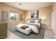 Spacious bedroom with light wood flooring and large windows at 13747 W Nogales Dr, Sun City West, AZ 85375