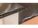 Close-up detail of a dark granite kitchen counter edge at 13747 W Nogales Dr, Sun City West, AZ 85375