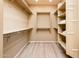 Large walk-in closet with shelves and hanging rods at 13747 W Nogales Dr, Sun City West, AZ 85375