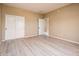 Bedroom with light wood floors and double door closet at 13747 W Nogales Dr, Sun City West, AZ 85375