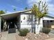 Single-wide manufactured home with carport and landscaping at 4065 E University Dr # 462, Mesa, AZ 85205