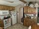 Kitchen with white appliances and wood cabinets at 4065 E University Dr # 462, Mesa, AZ 85205