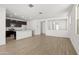 Open concept living room and kitchen with wood-look flooring at 8336 W Albeniz Pl, Tolleson, AZ 85353