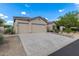 House exterior featuring a two-car garage and desert landscaping at 7358 E Red Hawk St, Mesa, AZ 85207