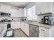 Modern kitchen with white cabinets, granite countertops and stainless steel appliances at 19731 N Ben Ct, Maricopa, AZ 85138