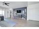 Gathering room with a large TV, built-in shelving, and a blue accent wall at 19731 N Ben Ct, Maricopa, AZ 85138