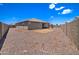 House's back view with a gravel backyard at 19731 N Ben Ct, Maricopa, AZ 85138