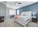 Bright bedroom with king-size bed and built-in workspace at 19731 N Ben Ct, Maricopa, AZ 85138