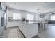 Modern kitchen with white cabinets, granite countertops, and an island at 19731 N Ben Ct, Maricopa, AZ 85138