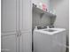 Laundry room with washer, dryer, and storage cabinets at 19731 N Ben Ct, Maricopa, AZ 85138