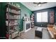 Bright office space with fireplace, built-in shelves, and a ceiling fan at 19731 N Ben Ct, Maricopa, AZ 85138