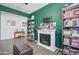 Home office with fireplace, built-in shelves, and an open floor plan at 19731 N Ben Ct, Maricopa, AZ 85138