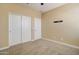 Simple bedroom with neutral walls, carpet, and closet at 19731 N Ben Ct, Maricopa, AZ 85138