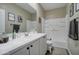Clean bathroom with white vanity, shower/tub combo, and built-in shelving at 19731 N Ben Ct, Maricopa, AZ 85138