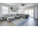 Spacious living room featuring a sectional sofa and sliding glass doors at 19731 N Ben Ct, Maricopa, AZ 85138