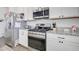 Clean and bright kitchen with stainless steel appliances and white cabinets at 19731 N Ben Ct, Maricopa, AZ 85138