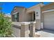 Front entry of a single story home with a two-car garage at 19731 N Ben Ct, Maricopa, AZ 85138