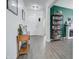 Entryway with wood-look floors, a bookcase, and access to other rooms at 19731 N Ben Ct, Maricopa, AZ 85138