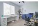 Home office with built-in shelving, desk, and comfortable chair at 19731 N Ben Ct, Maricopa, AZ 85138