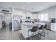 Open concept kitchen with white cabinets and granite island at 19731 N Ben Ct, Maricopa, AZ 85138