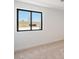 Simple bedroom with neutral carpeting and a large window at 16844 E Ave Of The Fountains -- # 201, Fountain Hills, AZ 85268