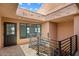 Building hallway with dark brown door and metal railing at 16844 E Ave Of The Fountains -- # 202, Fountain Hills, AZ 85268