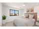 Bedroom with large window, plush bed and neutral decor at 16844 E Ave Of The Fountains -- # 202, Fountain Hills, AZ 85268