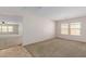 Spacious living room with tile flooring and views into another room at 17214 W Gibson Ln, Goodyear, AZ 85338