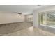 Spacious living room with tile and carpet flooring, and access to backyard at 17214 W Gibson Ln, Goodyear, AZ 85338