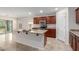 Modern kitchen with island, stainless steel appliances, and wood cabinets at 17214 W Gibson Ln, Goodyear, AZ 85338
