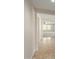 Light-filled hallway with tile flooring and neutral walls at 17214 W Gibson Ln, Goodyear, AZ 85338