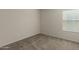 Well-lit bedroom featuring neutral walls and carpet at 17214 W Gibson Ln, Goodyear, AZ 85338