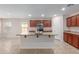 Modern kitchen with island, stainless steel appliances, and wood cabinets at 17214 W Gibson Ln, Goodyear, AZ 85338