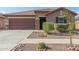 House exterior, with a two-car garage and landscaping at 17214 W Gibson Ln, Goodyear, AZ 85338