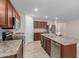 Modern kitchen with island, stainless steel appliances, and wood cabinets at 17214 W Gibson Ln, Goodyear, AZ 85338