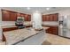 Modern kitchen with center island, stainless steel appliances, and wood cabinets at 17214 W Gibson Ln, Goodyear, AZ 85338