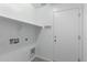 Bright laundry room with shelving and a door at 17214 W Gibson Ln, Goodyear, AZ 85338