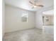 Open living area with ceiling fan and view into adjacent room at 2084 N 214Th Dr, Buckeye, AZ 85396