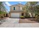 Two-story house with white garage door and landscaping at 2084 N 214Th Dr, Buckeye, AZ 85396