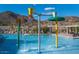 Community pool with water features and lounge chairs at 2084 N 214Th Dr, Buckeye, AZ 85396