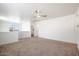 Bright and airy loft area with carpet and ceiling fan at 2084 N 214Th Dr, Buckeye, AZ 85396
