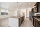 Kitchen with island, dark cabinets, granite counters, and stainless steel appliances at 2084 N 214Th Dr, Buckeye, AZ 85396