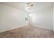 Spacious bedroom with neutral decor, carpet flooring, and a ceiling fan at 2084 N 214Th Dr, Buckeye, AZ 85396