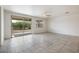 Spacious living room featuring tile floors and sliding glass doors to backyard at 2084 N 214Th Dr, Buckeye, AZ 85396