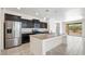 Modern kitchen with dark cabinets, granite countertops, and stainless steel appliances at 2084 N 214Th Dr, Buckeye, AZ 85396