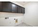 Laundry room with upper cabinets and space for washer and dryer at 2084 N 214Th Dr, Buckeye, AZ 85396