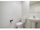 Clean bathroom with pedestal sink and updated toilet at 2084 N 214Th Dr, Buckeye, AZ 85396