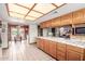 Modern kitchen with wood cabinets and black appliances at 5202 W Soft Wind Dr, Glendale, AZ 85310