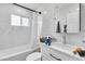 Updated bathroom with white vanity, bathtub, and marble-look tile at 131 W Tulsa St, Chandler, AZ 85225